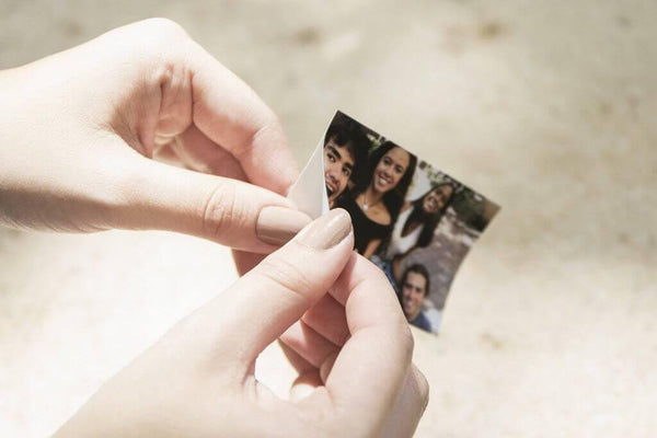 Hands peeling stickyback photo paper